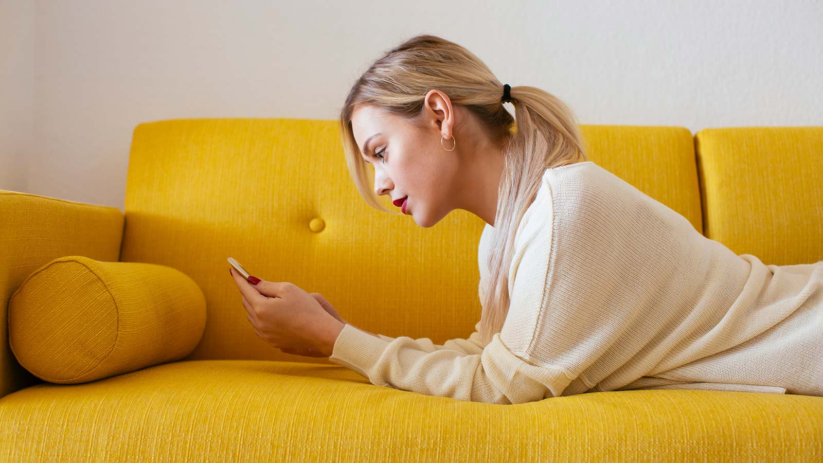 Nainen selaa asuntoja älypuhelimella